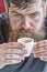 Guy relaxing with espresso coffee. Coffee break concept. Hipster drinking coffee close up. Caffeine recharge. Man with