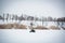 A guy rides a motorcycle on a frozen lake