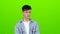 Guy is sad, he has a sorrowful look, he is upset. Green screen. Slow motion