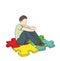 The guy is sitting on puzzles, the symbols of autism. vector illustration.