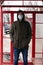 Guy stands at a bus stop in a medical disposable mask. respiratory viral disease protection covid-19 flu measles cold