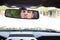 Guy sticking tongue out in rearview mirror