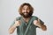 Guy thinks you doing great. Portrait of supportive friendly adult eastern man with beard and curly hair in green shirt