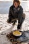 guy traveler cook scrambled eggs on fire. bushcraft, adventure, travel, hike concept