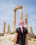 Guy with typical head cover in Jordan standing looking at ruins of the Temple of Hercules