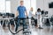 Guy with vacuum cleaner. Group of workers clean modern office together at daytime