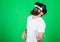 Guy with VR glasses learn to play music on guitar. VR musician concept. Man with beard in VR glasses, green background