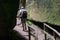 Guy Walking Down Wood Path in Mossy Canyon