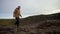 A guy walks along the edge of a cliff of a volcano. Extreme steps along the edge of the volcanic lake Kerid