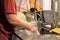 Guy washing dirty dishes in kitchen sink