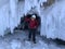 A guy in a white helmet comes out of the grotto of Lake Baikal. Ice cave on a frozen lake