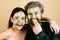 Guy with woman make mask for skin together, funny couple of lovers, isolated photo emotional. Funny couple with facial