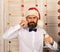 Guy on wooden wall background with red garlands.