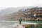 Guy young man alone with a travel backpack in Fenghuang Ancient town background. Fenghuang Ancient Town at after rainy day.