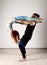 Guy and young woman doing strength exercises in yoga assanes. Acroyoga concept