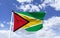 Guyana flag, mockup, fluttering under a blue sky