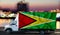 GUYANA flag on the side of a white van against the backdrop of a blurred city and river. Logistics concept