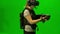 Guys in camouflage play shooting in virtual reality on a green background. VR shooter game with virtual reality headset testing