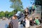 The guys are sitting on skateboards on the floor of the sports field,