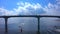 Guys on water bikes ride under a bridge in the Gulf of Finland.