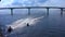 Guys on water bikes ride under a bridge in the Gulf of Finland.