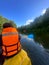 Guys, young women and men raft down the river in summer