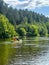 Guys, young women and men raft down the river in summer