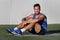 Gym fitness man portrait relaxing on exercise mat at outdoor park . Happy fit male athlete healthy active lifestyle ready for