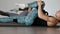 In the gym during the pilates exercise lying on the gym mats two girls lying on their back alternately pull their knees