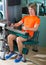 Gym seated leg curl machine exercise blond man