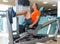 Gym seated leg press machine blond man workout