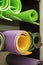 Gym shelf filled with colorful rolls for fitness, yoga and pilates