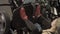 In gym woman presses feet up on training machine on sports equipment.