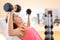 Gym woman strength training lifting weights