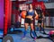 Gym woman with weighted ball and rope