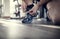 Gym workout routine man tying running shoes shoelace preparing for a jog or physical exercise