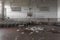 Gymnasium with stacked desks in abandoned high school