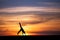 Gymnast doing cartwheel in sunset