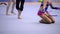 Gymnast legs on the field with ribbons in rhythmic gymnastics tournament