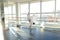 Gymnast in sportswear training near ballet barre in sport gym