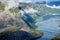 Gymnast standing on his hands on the edge with fjord on background near Trolltunga. Norway