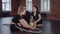 Gymnastics - three acrobatic women sitting on the floor with a ball and a hoop for gymnastics performance and talking