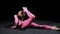 Gymnastics - A young plastic woman lies on the floor and performing exercises