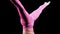 Gymnastics - young woman in pink costume performing exercises upside down