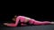 Gymnastics - young woman in pink costume sits in splits and performing exercises