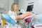 A gynecologist performs a colposcopy on a young girl in a gynecological chair in a modern medical office. Prevention and