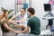 A gynecologist puts a blood pressure measuring device on the arm of a pregnant woman. A married couple in a gynecologist