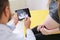 Gynecologist showing echo photo to pregnant woman.