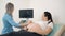 Gynecologist using ultrasound for checking pregnant woman