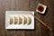 Gyozas, fried japanese dumplings served with soy sauce.